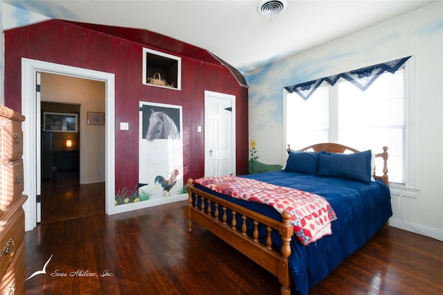 bedroom featuring vaulted ceiling and dark wood-type flooring