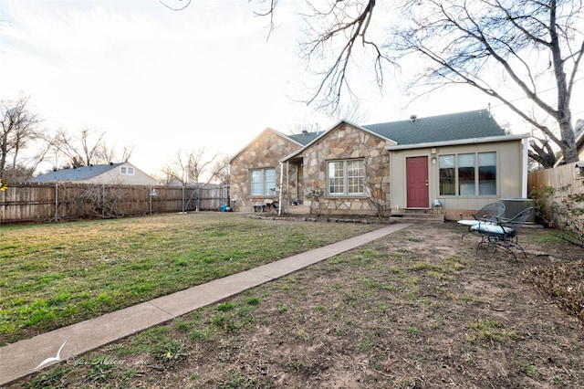 back of house with a yard