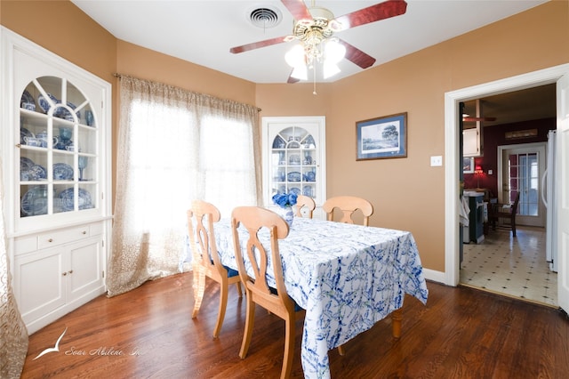 dining space featuring ceiling fan and dark wood-type flooring