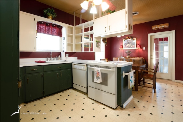 kitchen featuring stove, white cabinets, white dishwasher, and sink