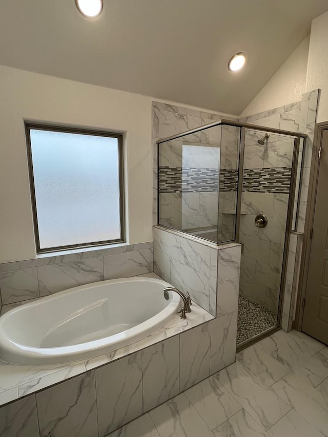 bathroom featuring lofted ceiling and shower with separate bathtub