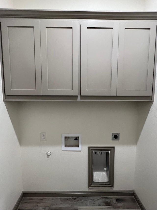 laundry area with hookup for an electric dryer, hookup for a washing machine, cabinets, gas dryer hookup, and dark wood-type flooring