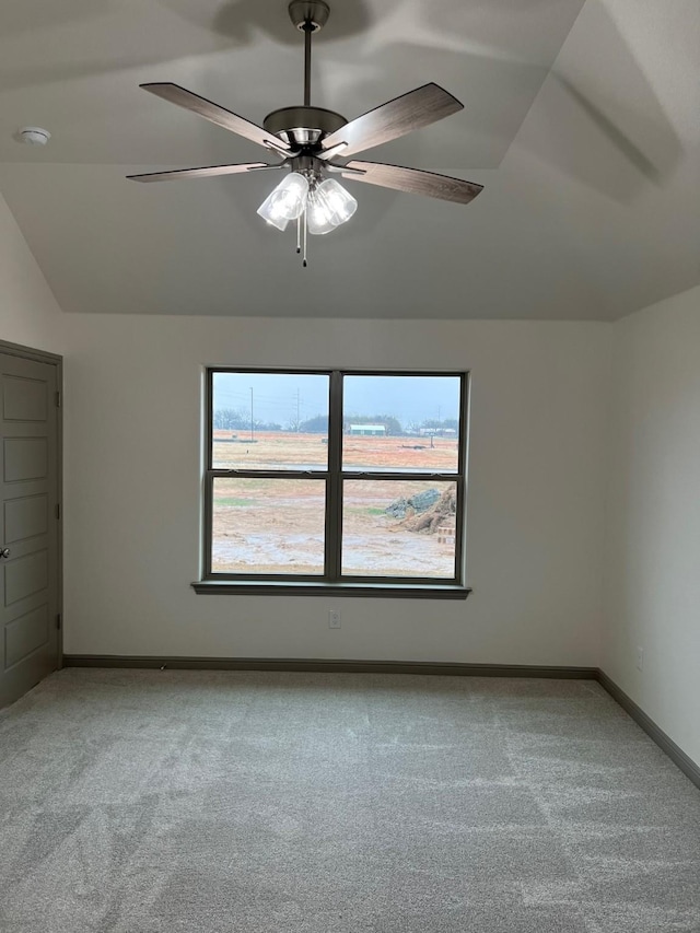 interior space featuring ceiling fan, light colored carpet, and lofted ceiling