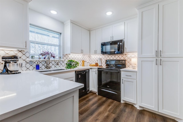 kitchen featuring white cabinetry, sink, tasteful backsplash, and black appliances