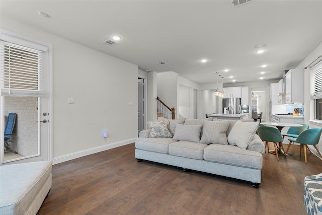 living room with dark hardwood / wood-style flooring