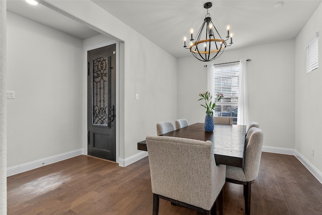 dining room featuring dark wood-type flooring and a notable chandelier