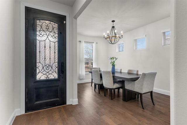 entrance foyer with dark wood-type flooring and a chandelier