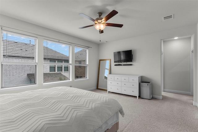 bedroom with ceiling fan and light carpet