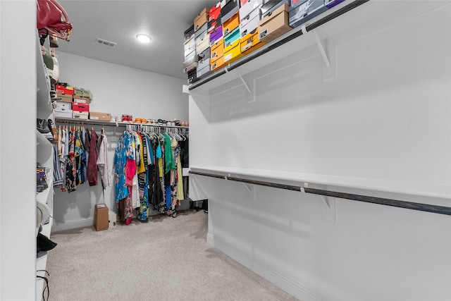 walk in closet with carpet flooring