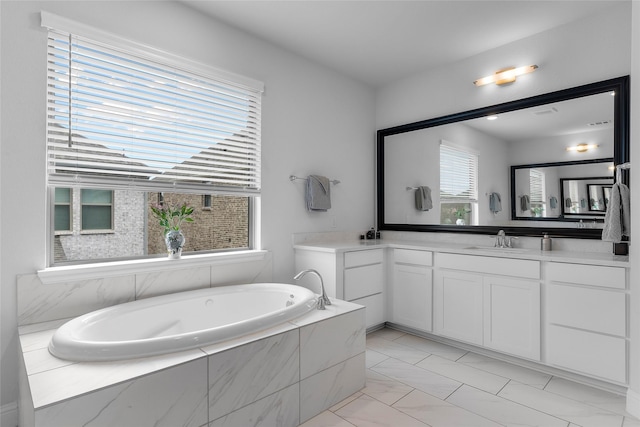 bathroom with a relaxing tiled tub and vanity