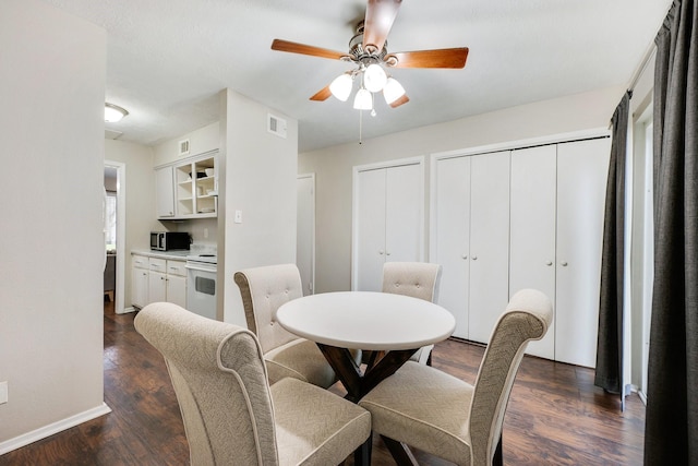 dining area featuring dark hardwood / wood-style floors and ceiling fan