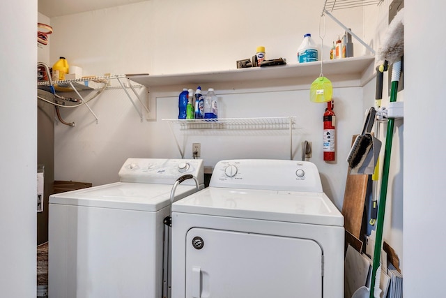 clothes washing area with washer and clothes dryer