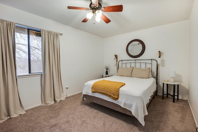 bedroom featuring multiple windows, ceiling fan, and carpet