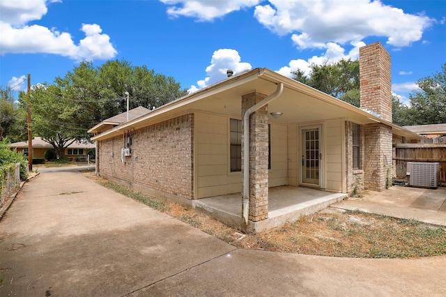 view of side of home featuring a patio area and central AC