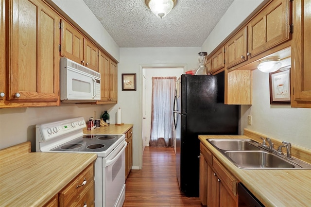 kitchen featuring a textured ceiling, dark hardwood / wood-style flooring, sink, and white appliances