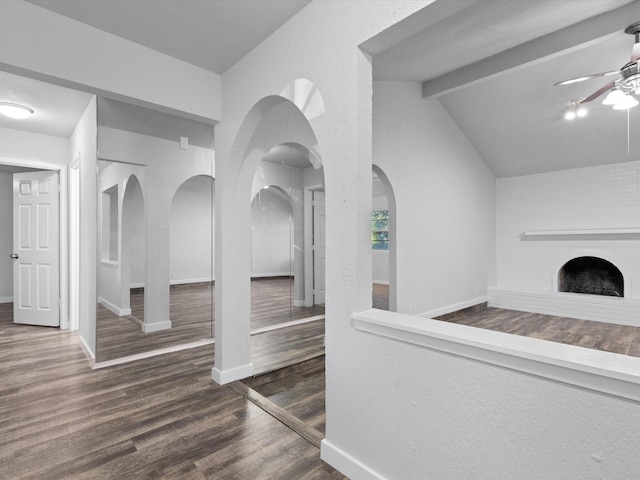 corridor with lofted ceiling with beams and dark hardwood / wood-style floors