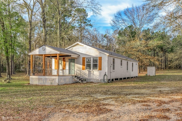 view of front of home with a porch and a front lawn