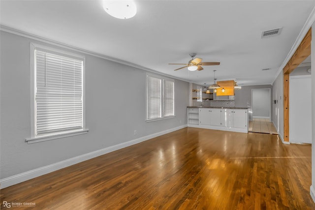 unfurnished living room with ceiling fan, crown molding, and light wood-type flooring