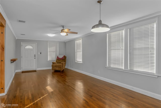 entrance foyer with crown molding, plenty of natural light, ceiling fan, and dark hardwood / wood-style flooring