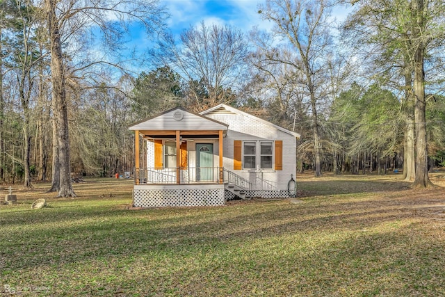 view of front of house featuring a front yard and covered porch