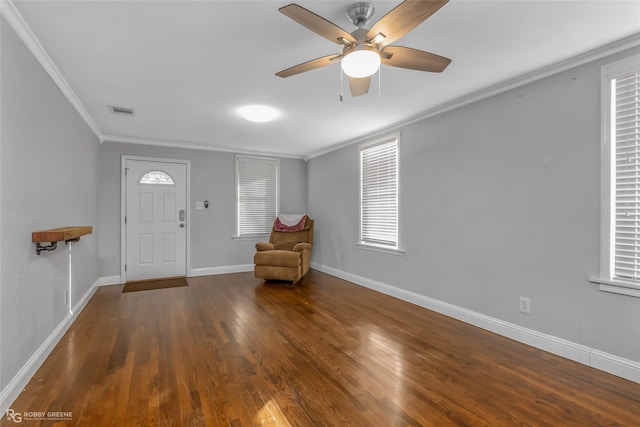 foyer entrance featuring dark hardwood / wood-style flooring, crown molding, and ceiling fan