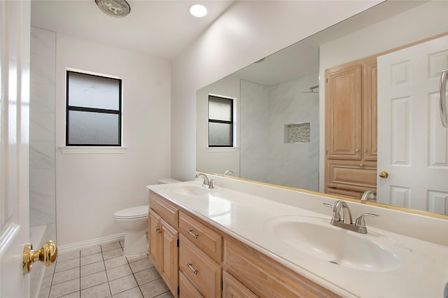 bathroom with tiled shower, tile patterned floors, vanity, and toilet