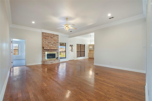 unfurnished living room with ceiling fan, a fireplace, crown molding, and hardwood / wood-style flooring