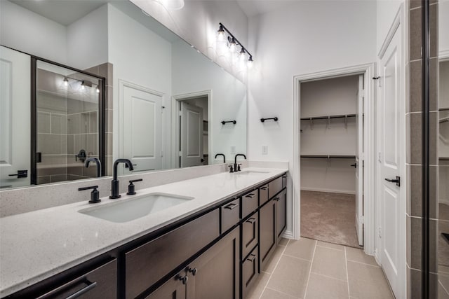 bathroom featuring tile patterned floors, vanity, and walk in shower