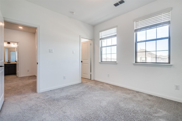 unfurnished bedroom with light carpet