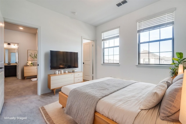 carpeted bedroom with multiple windows