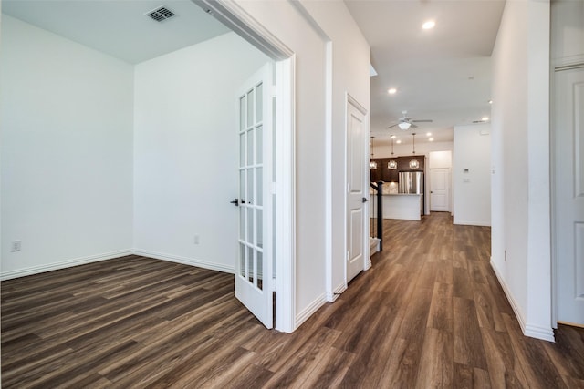 hallway with dark hardwood / wood-style flooring