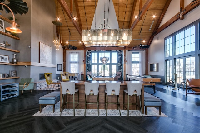 kitchen featuring wooden ceiling, beamed ceiling, an inviting chandelier, and high vaulted ceiling