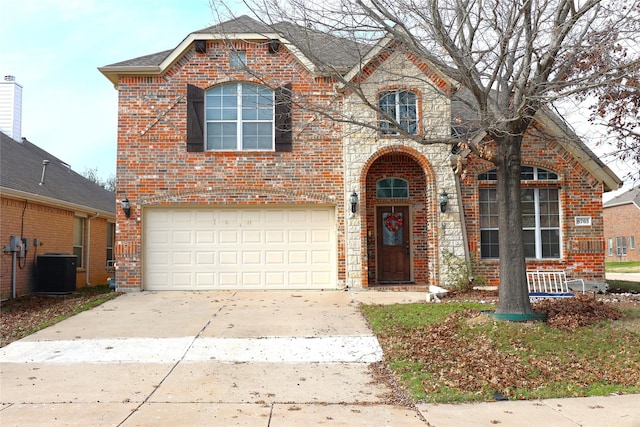 view of property featuring a garage and central AC