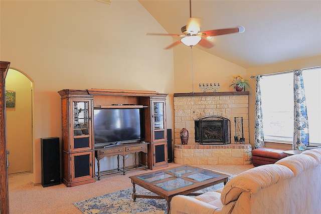 carpeted living room with a fireplace, high vaulted ceiling, and ceiling fan