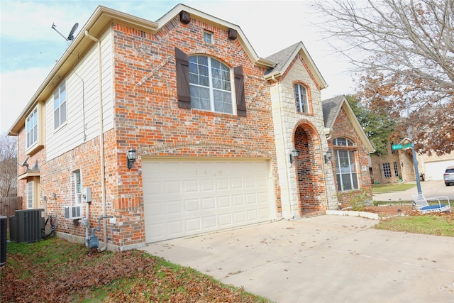 view of property with central AC unit and a garage