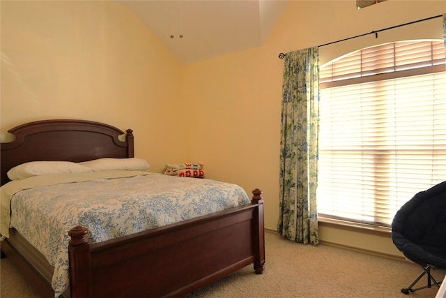 bedroom featuring vaulted ceiling and carpet