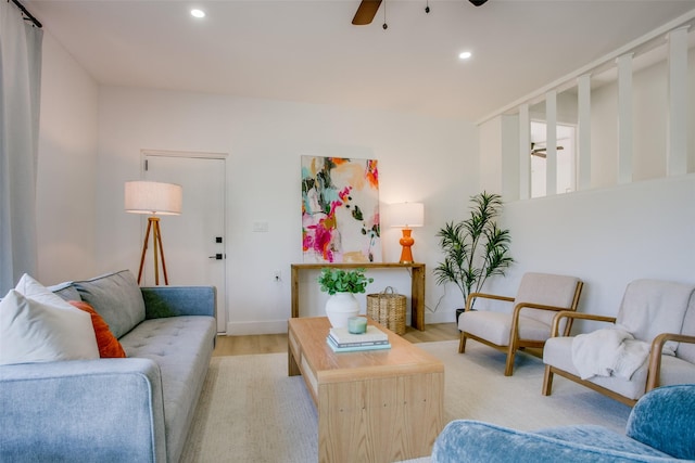 living room with ceiling fan and light hardwood / wood-style flooring