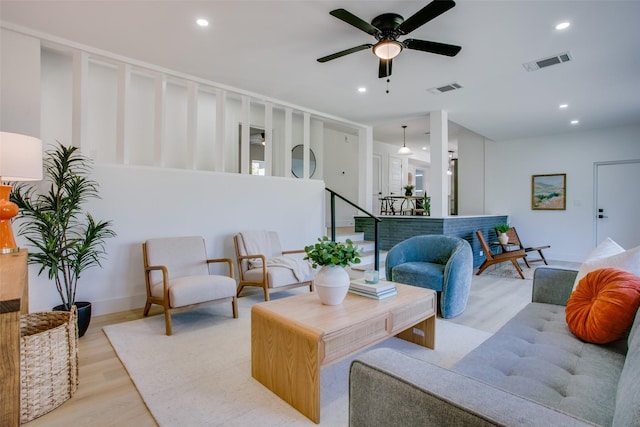 living room with ceiling fan and light wood-type flooring