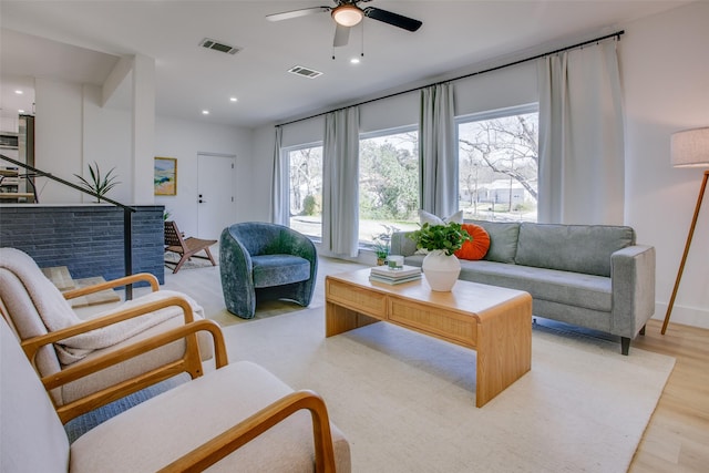 living room featuring ceiling fan and light hardwood / wood-style floors