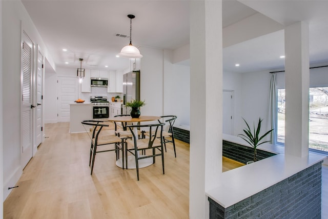 dining area with light wood-type flooring