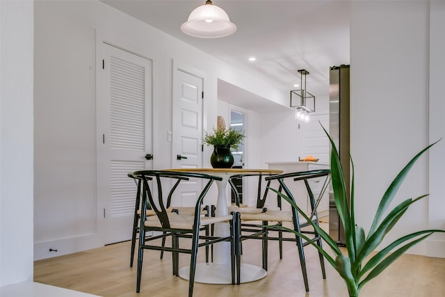 dining space with light hardwood / wood-style floors