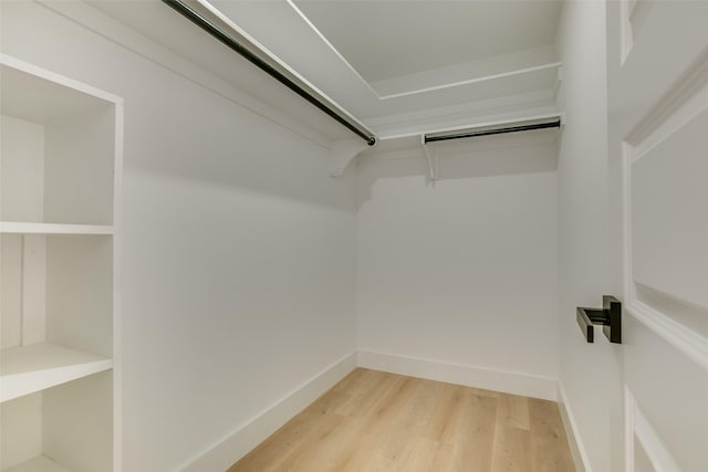 walk in closet with hardwood / wood-style floors