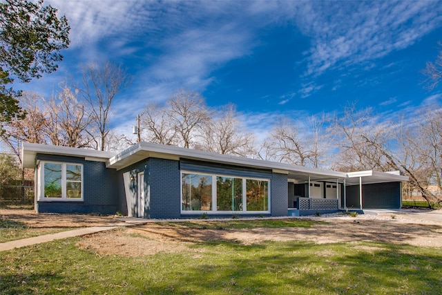 rear view of property with a yard