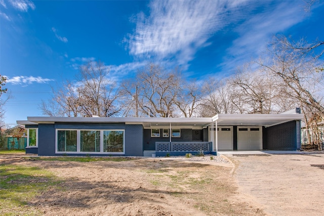 ranch-style home with a porch and a carport