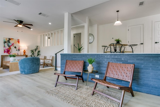 sitting room featuring light hardwood / wood-style flooring and ceiling fan