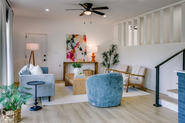 living area featuring ceiling fan and light wood-type flooring