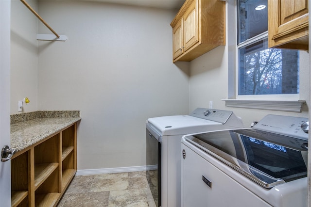 washroom with washer and clothes dryer and cabinets