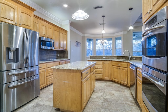 kitchen with stainless steel appliances, sink, pendant lighting, a chandelier, and a kitchen island