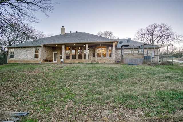 back of house featuring a yard