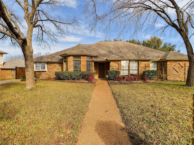 ranch-style home with a front lawn